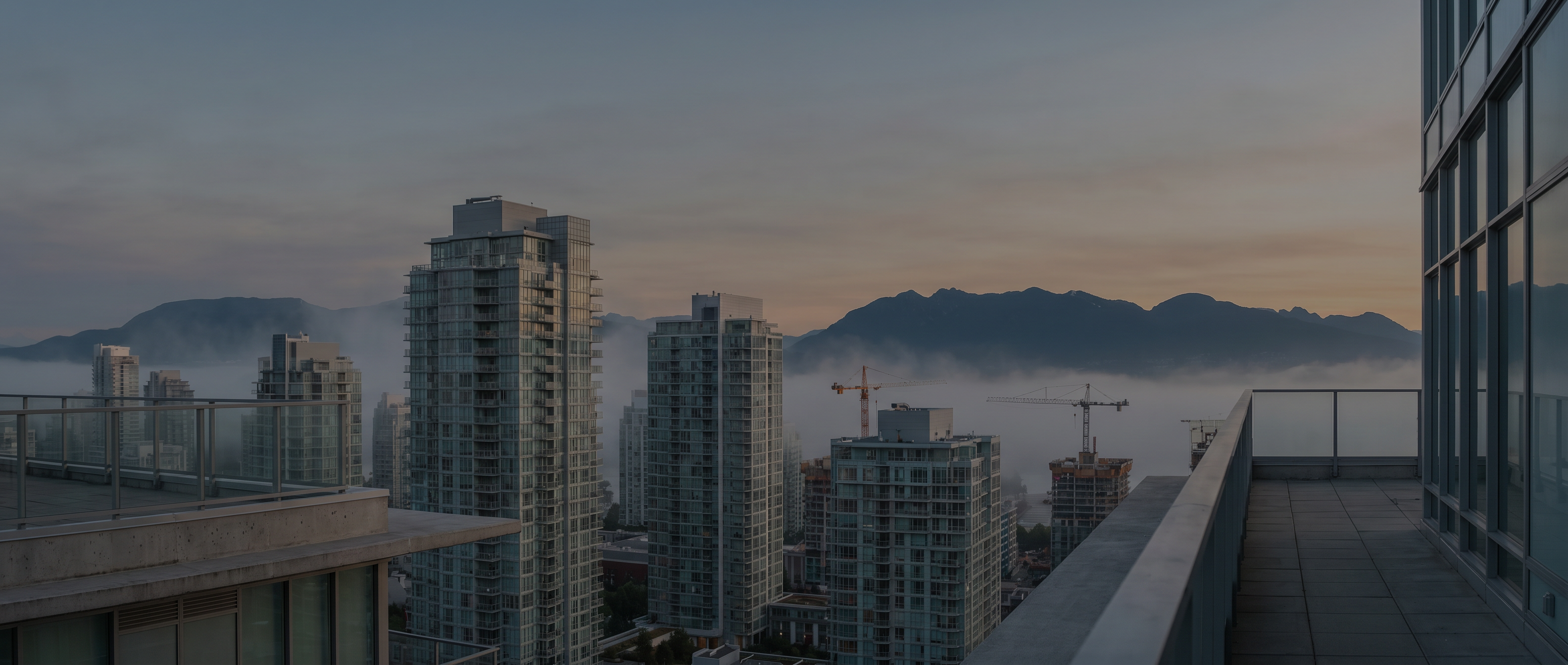 Vancouver cityscape with construction cranes at dawn