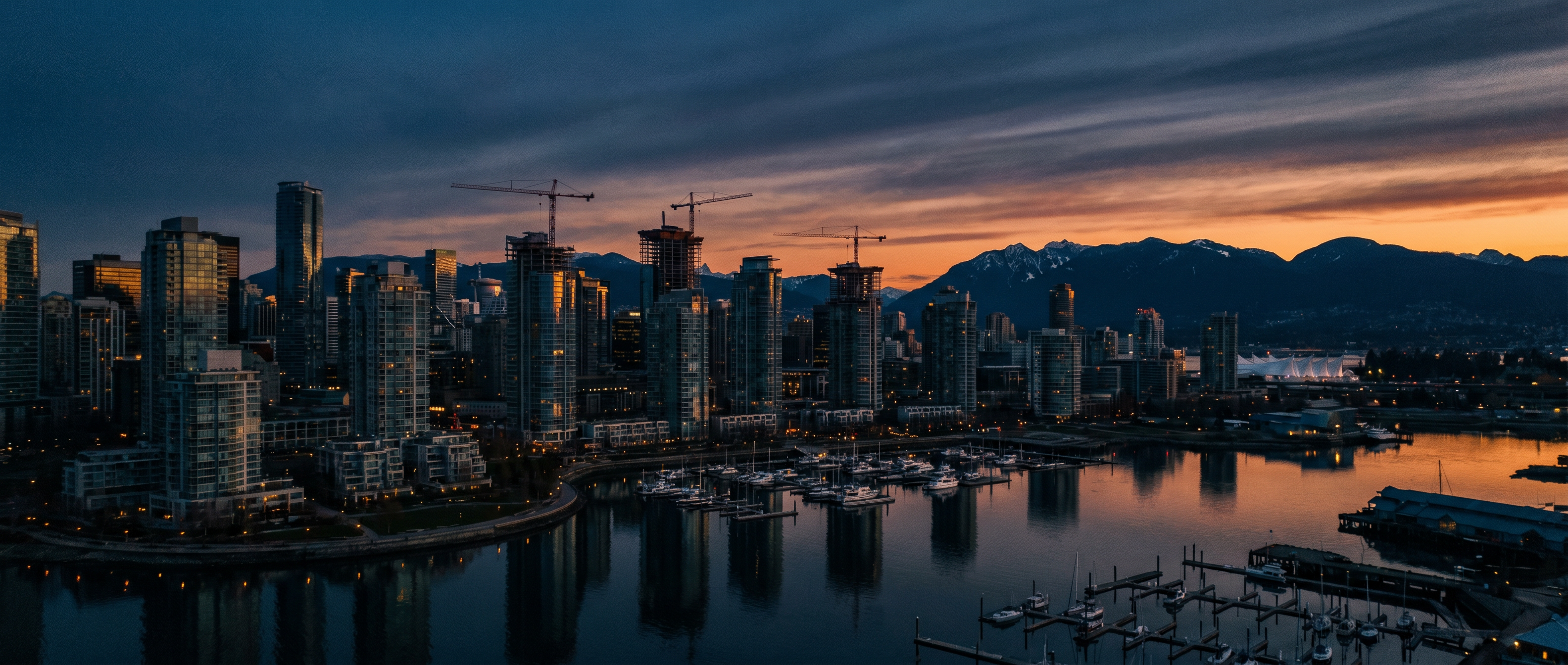 Vancouver skyline with construction cranes at sunset
